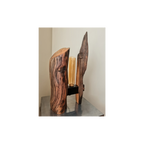 Wooden lamp with a unique design on a reflective surface