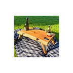 Wooden wine table with bottles on a grassy background