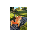 Wooden wine table with bottles and glasses on a checkered blanket in a park
