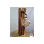 Wooden table lamp with a glass bulb on a white background