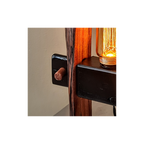 Wooden lamp with black brackets against a white wall.
