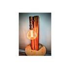 Wooden lamp with a glowing light bulb on a white background