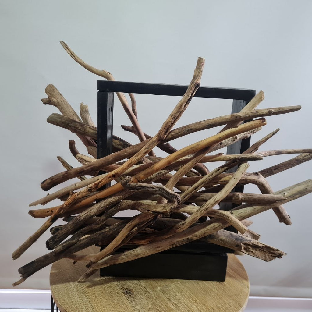 Driftwood lamp with a warm glow on a white background