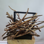 Driftwood lamp with a warm glow on a white background