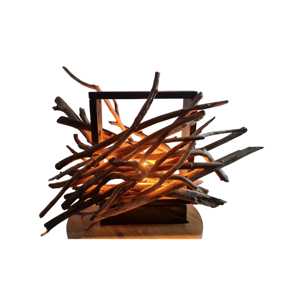 Driftwood lamp with a warm glow on a white background