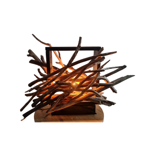 Driftwood lamp with a warm glow on a white background
