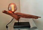 Wooden lamp with a lit bulb on a white background