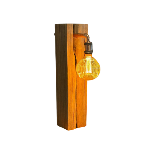 Wooden table lamp with a lit bulb on a white background