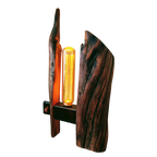 Wooden lamp with a unique design and a glowing bulb on a white background
