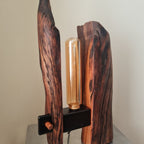 Wooden lamp with a cylindrical light bulb on a neutral background