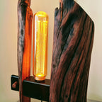 Wooden lamp with a glowing light bulb on a plain background