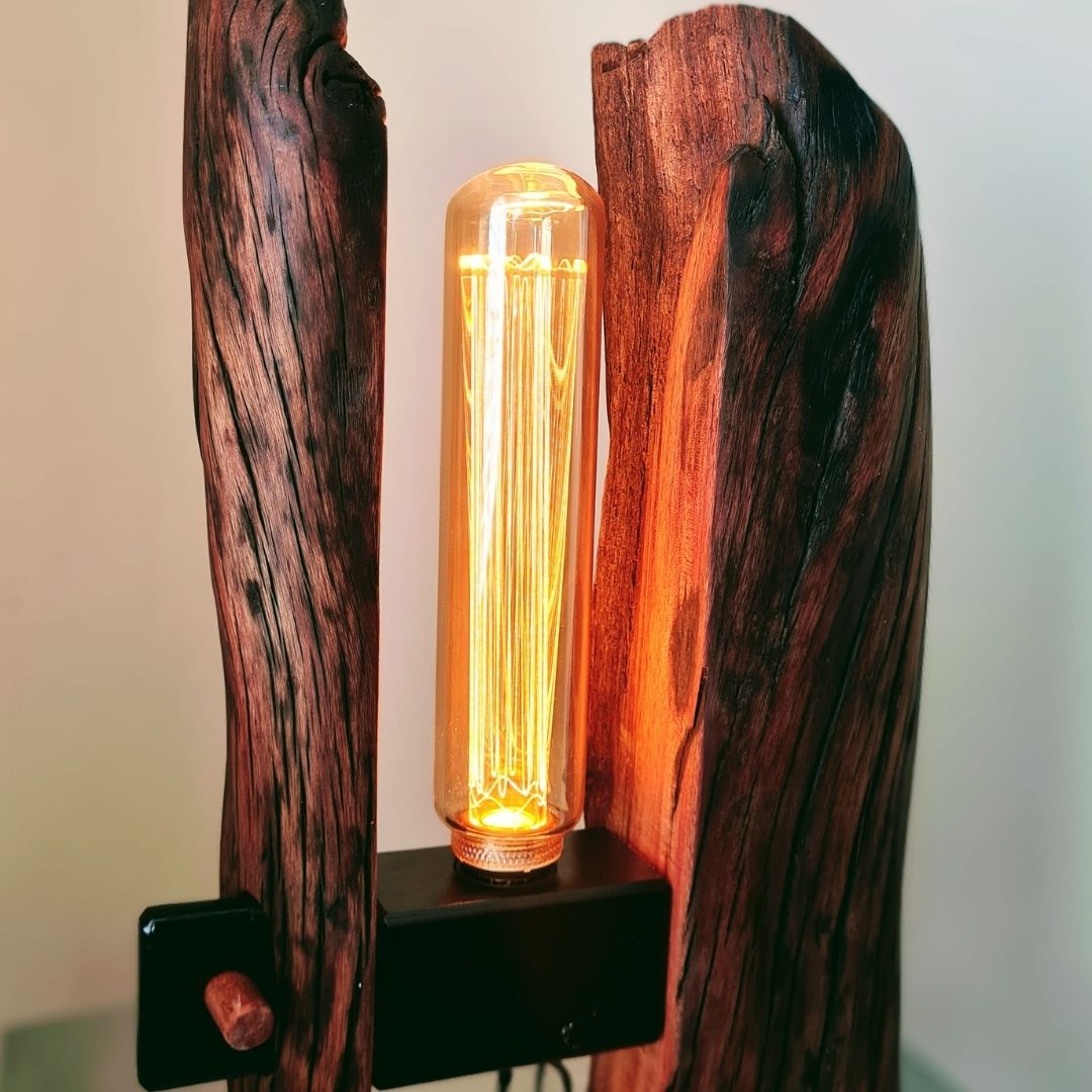 Wooden lamp with a glowing light bulb inside